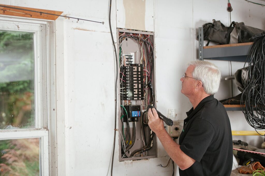 technician inspecting a dryer wall box on an exterior wall